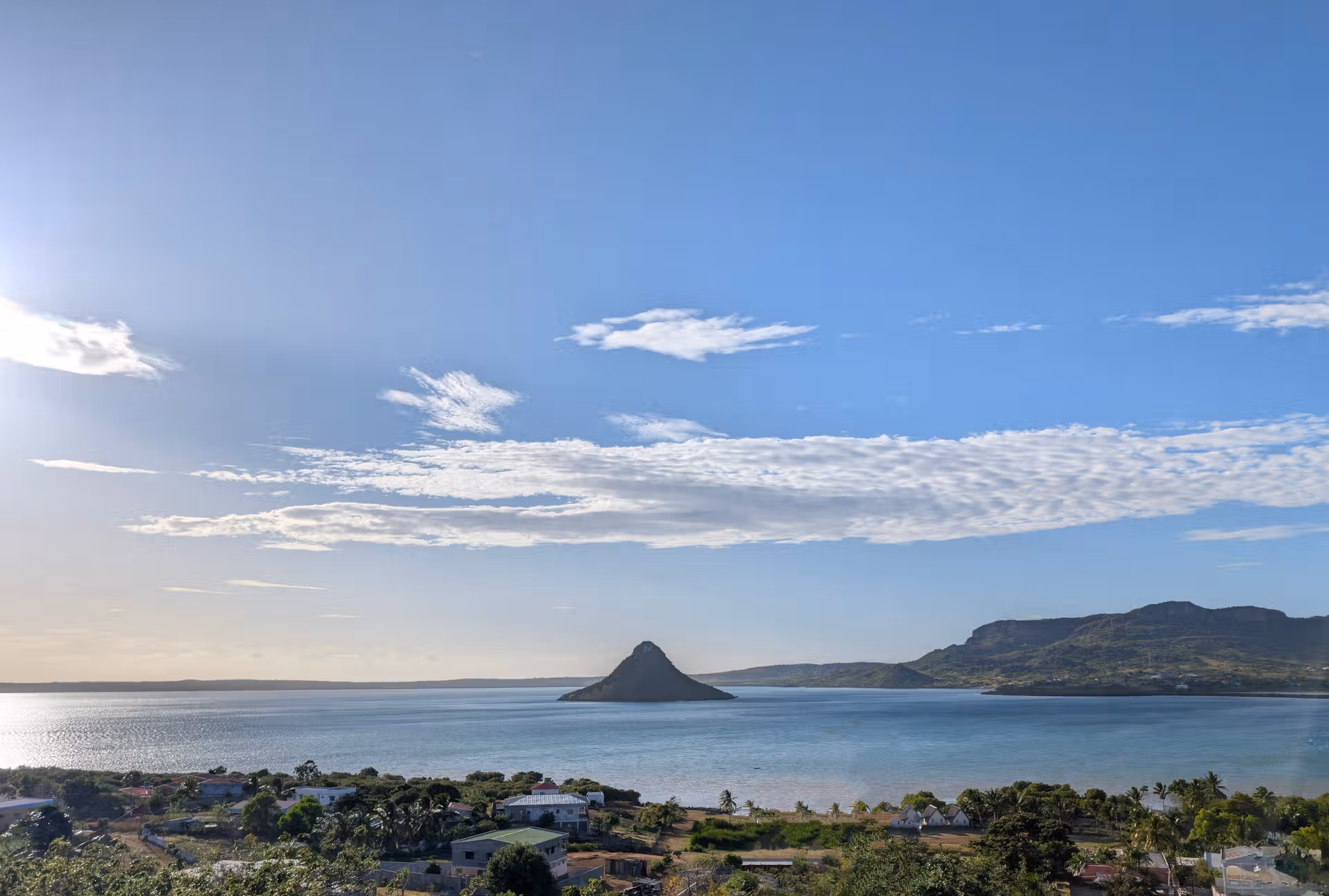 An image showing off a sugar loaf island in the middle of the sea with a blue sky in background representing the Antsiranana Diego Suarez city, landscape captured by FAR Madagascar